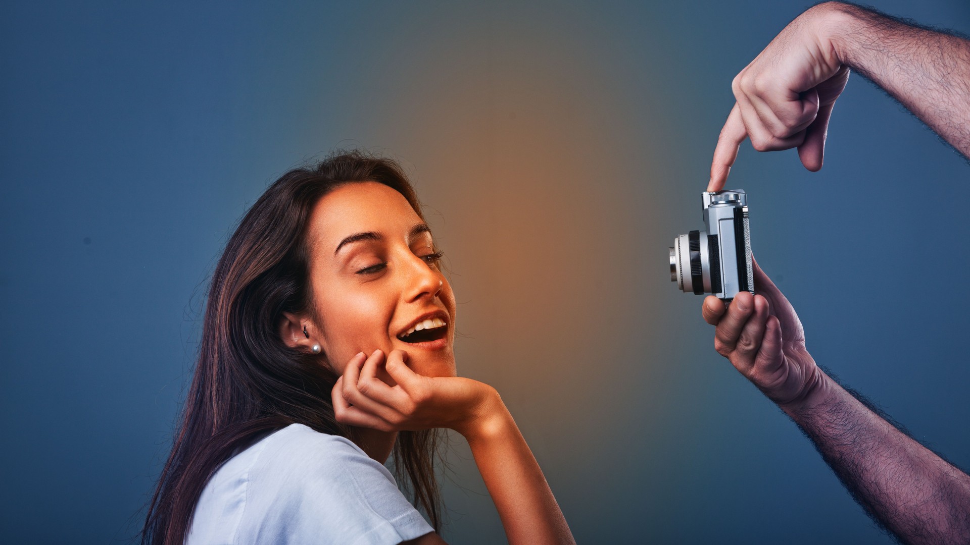 Photographer taking a picture of a smiling young woman with vint